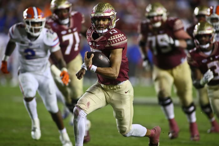 Florida State quarterback Jordan Travis (13) runs on a keeper during the fourth quarter of the team's NCAA college football game against Florida on Friday, Nov. 25, 2022, in Tallahassee, Fla. Florida State won 45-38.